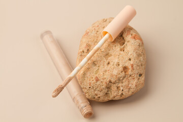Concealer on a beige background. Decorative cosmetics