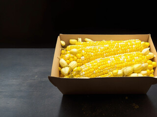 Top view fresh raw corn yellow plant on a dark-light table color green photo