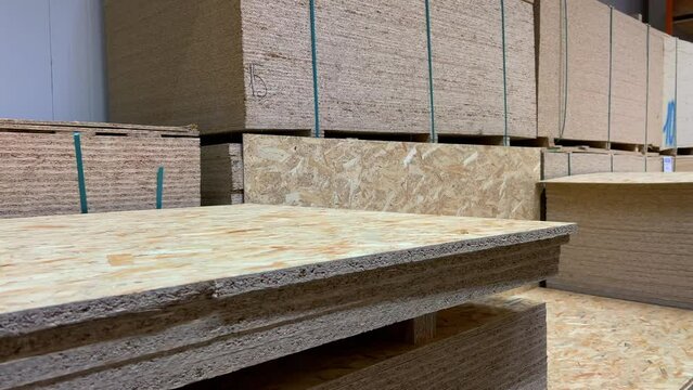Sheets chipboards stacked in the warehouse of a woodworking factory