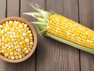Top view fresh raw corn yellow plant on a dark-light table color green photo