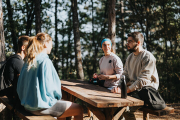 Friends enjoys a sunny day hiking in the forest. They exercise, explore, and have fun conversations in the fresh, green environment. It's the perfect outdoor adventure for active, happy people.