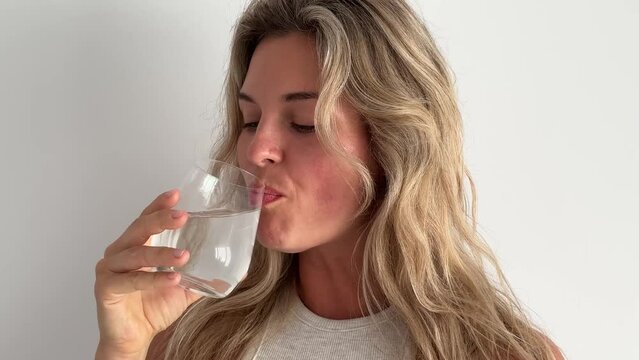 Beautiful woman drinking glass of water.