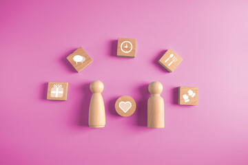 couple with love and wooden block on pink background.family relationship and happiness concept.