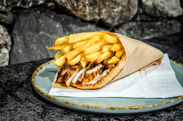 Close-Up Gyros Deligh. Greek street food. Ideal for food enthusiasts, travel blogs, and anyone craving a taste of the Mediterranean. Slices of perfectly seasoned meat, nestled in a warm pita.