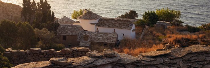 Panoramic view to a historic monastery with traditional slate roofs on the laid-back North Aegean...