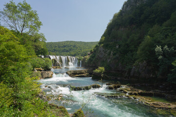 Fototapeta na wymiar Waterfall, water cascade on the river