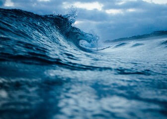 the ocean waves at dusk, taken from under water with blue tones