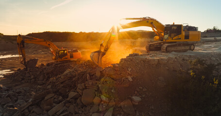 Aerial Drone Shot Of Construction Site On Sunny Day: Industrial Excavators Digging Rocks To Lay...