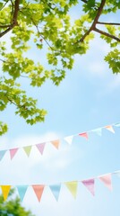 Vibrant blue sky backdrop with lush green tree branches, adorned with strings of small triangle flags, creating a festive summer atmosphere with ample open blue space for text.