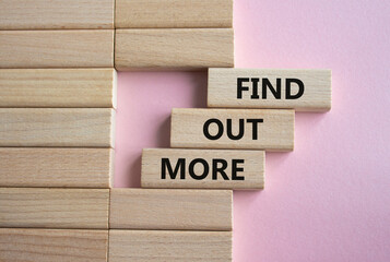 Find out more symbol. Concept word Find out more on wooden blocks. Beautiful pink background....