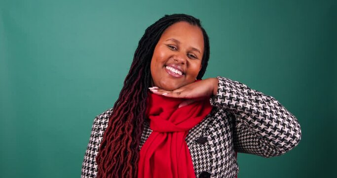 Young woman smiles and poses dressed in Christmas colours, studio video