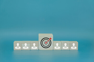 Businessman icon on wooden block and target icon in the middle, teamwork concept to bring success...