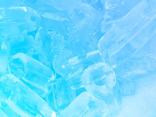 Blue Transparent crystals on blue background. Fresh cool ice cube background