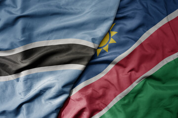 big waving national colorful flag of botswana and national flag of namibia .