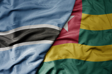Obraz premium big waving national colorful flag of botswana and national flag of togo .
