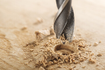 metal drill bit make holes in wooden oaks plank