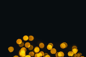 background, texture. Yellow round bokeh stars on black background