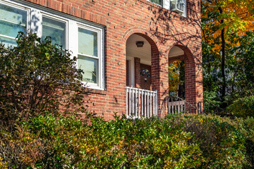 Old brick house facade with arched entrance, Brighton, Massachusetts, USA