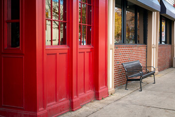A bench on the sidewalk in front of a restaurant facade on Boston, USA