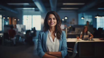 Fototapeta na wymiar Portrait of smiling businesswoman standing with arms crossed in creative office