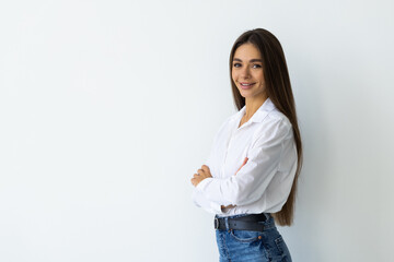 Portrait of woman standing with arms folded isolated on a white background