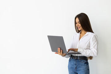 Naklejka premium Portrait of young woman in casual outfit with laptop isolated on white background
