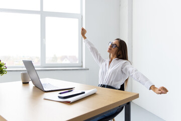Photo of young happy woman work in laptop raise fists in victory at home