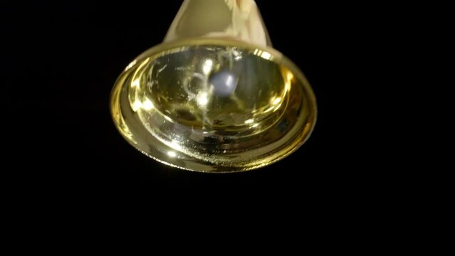 4K - Ringing Christmas bell. Slowly on camera
