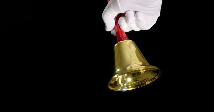 4K - A hand rings a Christmas bell. Slow-mo