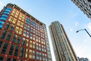 Low angle view of an office buiding alongside a residential tower on a clear spring day