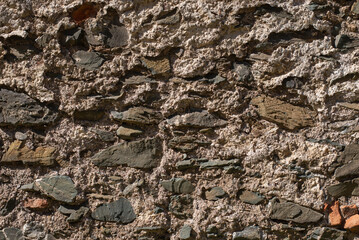 Medieval brick wall close up. Texture background of an old wall made of stone rocks.