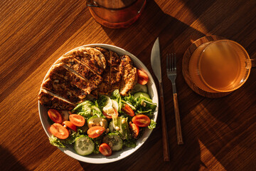 Light breakfast with chicken and vegetables with a mug of tea.