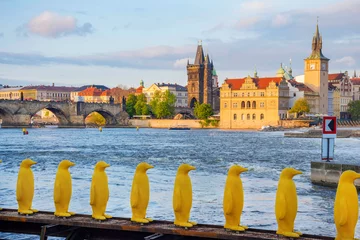 Tableaux ronds sur aluminium brossé Pont Charles Museum Kampa's Yellow Pinguins, modern art in Prague, Czech Republic and view of old town with Charles Bridge on Vltava river in the background, at sunset
