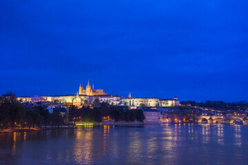 Vltava river with famous Hradcany castle and St. Vitus Cathedral in Prague, Czech Republic, by night