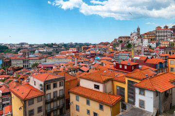 Fototapeta na wymiar Aerial view of old town of Porto with orange rooftops buildings, Portugal. Medieval architecture of Oporto downtown. Travel destination