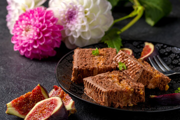 Chocolate cake cut into square pieces with nut cream