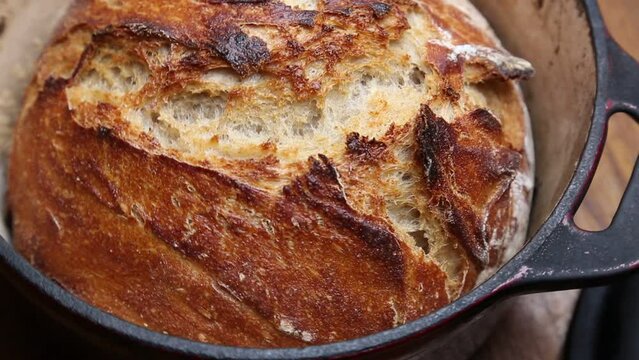 bread loaf in dutch oven (no knead sourdough recipe) turning pot footage (rustic, country, boule, caramelized, colorful) toasted, crusty, delicious