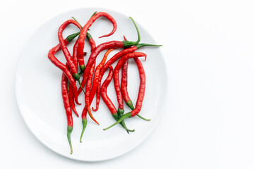Indonesian best quality red hot chilies. A bunch of fresh curly red chilies isolated on white...