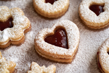 Heart shaped Linzer Christmas cookie filled with strawberry marmalade and dusted with sugar