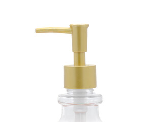 Fototapeta na wymiar Close up of gold color squirt bottle pump cap used for hand, face or body soap and lotion or hair shampoo isolated on white background. gel lotion mousse product