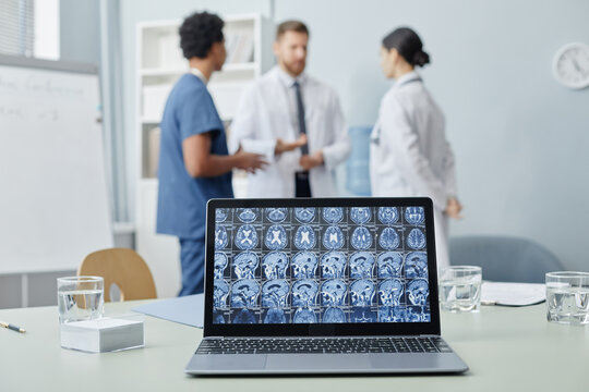 Background image of open laptop with X ray images on screen on meeting table in medical clinic, copy space