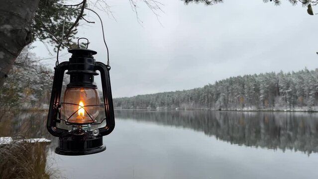 kerosene lantern near a winter lake