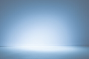 Empty light blue background for product presentation with light and shadow on the wall and floor