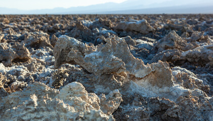 Salt desert, cracked crystalline salt. Dry cracked earth in Salt Flats, Death Valley