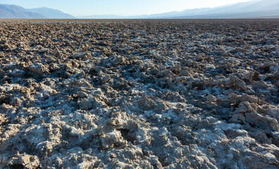 Salt desert, cracked crystalline salt. Dry cracked earth in Salt Flats, Death Valley