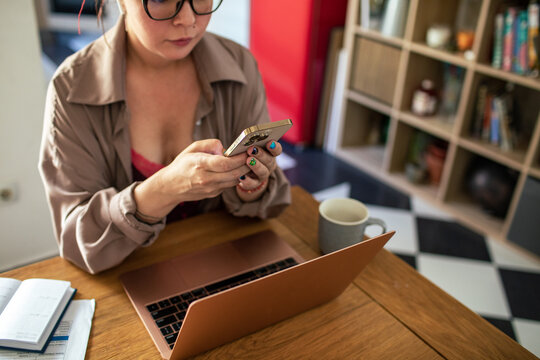 Woman Multitasking with Technology at Home Office