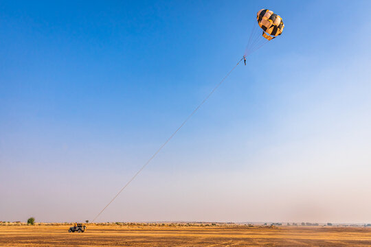 Parasailing near Sam sand dunes of Jaisalmer in great Thar desert, Rajasthan state, India.
