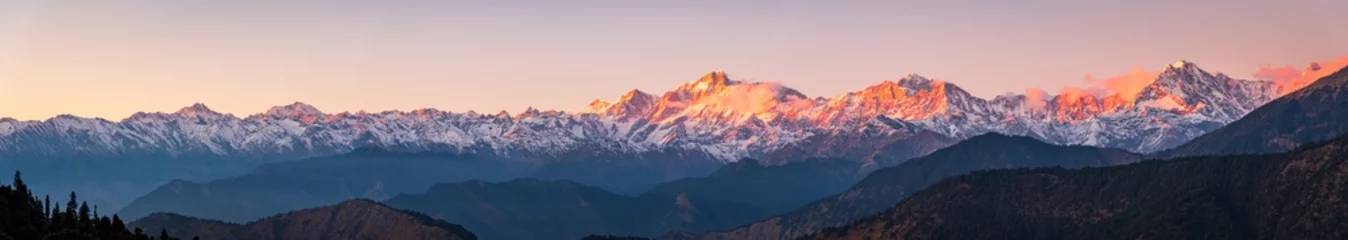 Fotobehang Himalaya Panoramic view during sunset over snow cladded gangotri group mountain peaks falls in Greater Himalayas mountain range from Chopta, Uttarakhand, India.