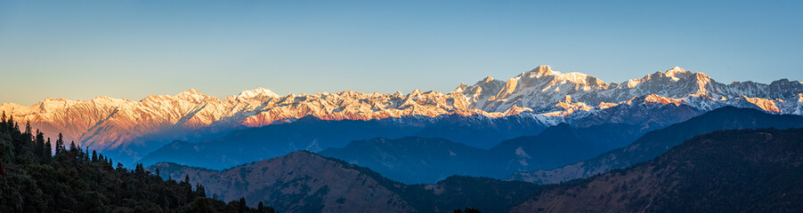 Panoramic view during sunset over snow cladded gangotri group mountain peaks falls in Greater...