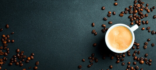 A cup of fragrant arabica or robusta coffee. Espresso. Top view, on a black background. Natural...